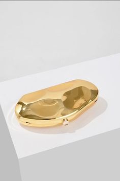 a gold plate sitting on top of a white table