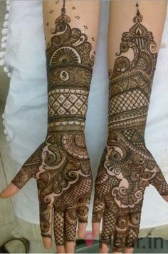 two hands with henna designs on them