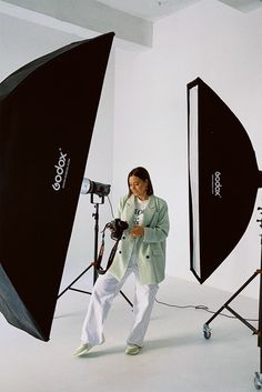 a woman is walking in front of a camera