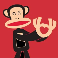 a cartoon monkey holding the letter b in his right hand and pointing at it with both hands