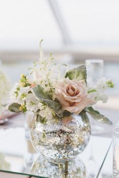 a vase filled with flowers sitting on top of a table