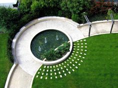 an aerial view of a circular garden pond