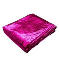 a bright pink blanket folded on top of each other in front of a white background