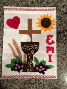 a cross, sun and flowers on a white towel