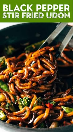 a bowl filled with noodles and broccoli on top of a table next to a fork