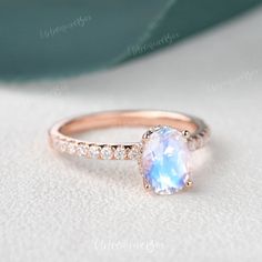 a ring with an oval cut blue topazte surrounded by small white diamond accents