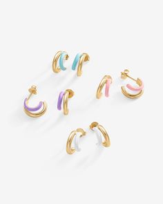 Dive into a world of trendy elegance with our colored enamel huggie earrings. These petite treasures seamlessly merge with any outfit, elevating your look whether it's a daytime casual or evening sophistication. With their compact design, they're as comfortable as they are chic.Materials: 14K yellow or white gold plated. 925 sterling silver posts. Blue, Pink, Purple or White Enamel. Measurements: Outer Diameters: 13mm, and 10.5mm. Width: 6.5mm; Thickness: 2.4mm. Trendy Gold Enamel Hoop Earrings, Small Elegant Enamel Hoop Earrings, Luxury Small Hoop Enamel Earrings, Yellow Gold Enamel Hoop Earrings, Gold Enamel Hoop Earring (sold Individually), Dangle Necklaces, Toggle Bracelet, Beaded Anklets, Bracelet Collection