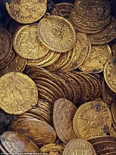 a pile of gold coins sitting next to each other