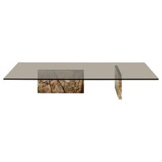 a glass table that has some rocks on it and is in the shape of a rectangle