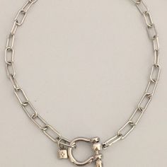 Carabiner Chain choker Carabiner Chain Necklace-Choker Necklace-Clasp Chain Necklace-Silver Cable Necklace-Silver Shackle Necklace-Shackle Jewelry-Padlock Charm A beautiful shiny silver chain made up of paperclip links. The chain is brass and has several plating coatings of color to give the silver electroplated finish. It is a high quality chain choker chain. The anchor shackle clasp gives the necklace a modern and unusual edge. It is Silver Plated - Rhodium Plated. Size 21 x 25 mm To finish off this neck shackle I added a small CZ padlock with a CZ bail. The padlock also features a CZ star. If you look at the pictures you can see that the shackle clasp unscrews and the chain link is easily navigated both off and onto the shackle. This is a modern and versatile necklace. Very much on tren Silver Metal Necklace With Carabiner Clasp, Silver Necklace With Carabiner Clasp In Metal, Silver Link Chain Necklace With Carabiner Clasp, Silver Link Jewelry With Carabiner Clasp, Silver Necklaces With Hook And Links For Everyday, Everyday Silver Necklace With Hook And Links, Silver Toggle Clasp Chain Choker, Silver Link Toggle Necklace With Lobster Clasp, Silver Toggle Choker Necklace With Lobster Clasp