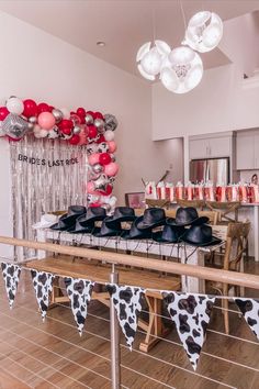 cowprint banner, brides last ride bachelorette party, balloon arch, disco cowgirl, bachelorette goody bags, bach bags, black cowgirl hats all sitting on kitchen table, balloon arch on wall in the kitchen, disco ball balloons, pink balloons, cowpirnt balloons Disco Cowgirl Bachelorette Party Decor, Cowgirl Bach Theme, Cowgirl Hat Bachelorette Party, Cowgirls Bachelorette Party, Cowgirl Hats Bachelorette Party, Bachelorette Party Ideas Last Rodeo, Bachelorette Party Decorations Cowgirl, Leather Jacket Bachelorette Party, Last Rodeo Bachelorette Party Ideas