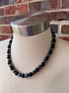 A medium weight beaded mens necklace made with lava rock and hematite beads. - Length is 19" (more lengths are listed)- Gunmetal lobster claw clasp (more options available)- 8mm beads - Heavy duty flexible nylon coated stainless steel beading wire To get the correct length, add at least 1.5"- 2" to your dress shirt neck size. This will give you a short choker fit with a little extra room. Otherwise choose a longer length. The mannequin's neck size is 14.5". A matching bracelet can be added to yo Beaded Necklace Designs For Men, Men Bead Necklace, Men Beaded Necklace Ideas, Mens Jewelry Aesthetic, Men Beaded Necklace, Male Jewellery, Beaded Necklace For Men, Mens Choker Necklace, Men Choker