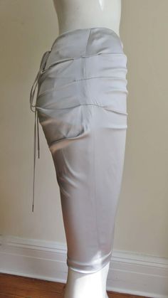 For Sale on 1stDibs - A gorgeous light grey stretch silk skirt from Dolce & Gabbana. It is a pencil style skirt with horizontal ruching across the front and back. There is functional Elegant Draped Bottoms With Ruched Sides, Elegant Spring Draped Skirt With Ruched Sides, Elegant Bottoms With Gathered Waist For Spring, Elegant Spring Bottoms With Gathered Waist, Elegant Draped Skirt With Ruched Sides, Elegant Fitted Draped Skirt With Ruched Sides, Elegant Fitted Draped Gathered Skirt, Ruched Skirt For Formal Summer Occasions, Elegant Ruched Bottoms For Spring