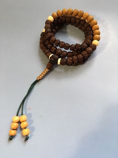 Old Rudraksha Mala Necklace with Sandalwood and Bone. Laid out iin a Zen sequence with an adjustable knot. Great for meditation mindfulness Adjustable Necklaces With 8mm Beads For Festivals, Adjustable Mala With 108 Beads For Rituals, Adjustable Mala With 8mm Beads For Festivals, Adjustable Spiritual Mala For Festivals, Adjustable Wooden Beads Necklace For Festivals, Adjustable Hand Wrapped Mala For Healing, Adjustable 8mm Beads Mala For Festival, Adjustable Brown Mala For Healing, Adjustable Brown Mala For Festival