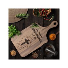 a wooden cutting board with spices and herbs around it on top of a wood table