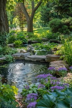 a small pond surrounded by trees and flowers