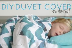 a young child sleeping under a blanket on top of a bed with the words diyduvet cover