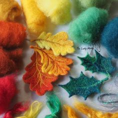 several different colors of wool with leaves on them