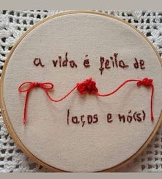 a close up of a embroidery on a piece of cloth with words written in spanish