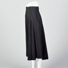 "This listing is for one skirt. Textile is unmarked. Full skirt with pleated waistband. This is a very lovely black skirt with a nice sweep. Beautiful drape and movement. Wide waistband with horizontal pleats. Left side zip with button and loop closures at the waistband. Size Marked: Unmarked Approximate Size: Medium **Please Check Measurements to be Sure! Fabric: Unmarked Lining Type: None Closure: Zip Label: Unmarked Condition: Excellent Era: 1950s Inventory#: DSC1018-1984 Measurements- Waist: Classic Long Skirt Bottoms For Evening, Black Bottoms With Pleated Waist For Evening, A-line Pleated Skirt For Evening, Pleated Flared Skirt For Evening, Flared Evening Bottoms With Pleated Hem, Black Pleated Bottoms For Daywear, Luxury Flared Skirt With Pleated Hem For Evening, Evening Bottoms With Pleated Hem Full Skirt, Evening Full Skirt Bottoms With Pleated Hem