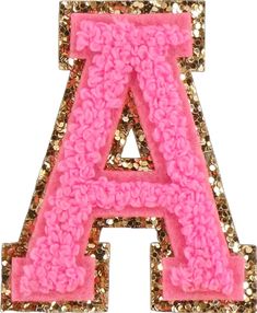 pink and gold sequinized letter brooch with flowers on the front, set against a white background