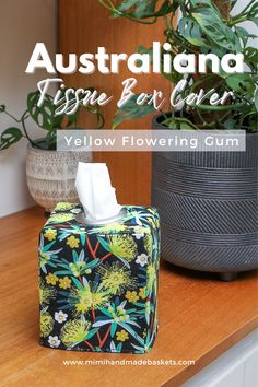 an australian tissue box cover with flowers on it and the words yellow flowering gum written in white