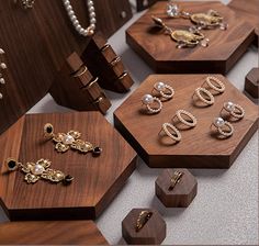 several wooden boxes with rings and pearls on them