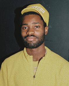 a man in a yellow shirt and hat