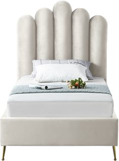 a bed with white linens and pillows on top of it, next to a pillow