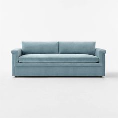 a blue couch sitting on top of a white floor