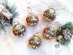 four personalized christmas ornament ornaments on a fur surface