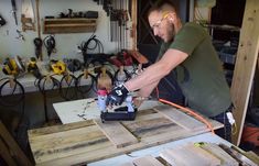 a man is working on some wood with a power drill and an electric sawtoother