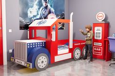 a child's play room with a toy train and captain america poster on the wall