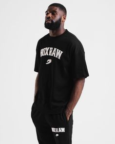 Inspired by the roots of MSG, the East Street Oversized T-Shirt pays homage to the origins of the Mecca of Boxing. Made from a durable heavy cotton blend, this t-shirt offers an oversized fit and features an applique BOXRAW Logo on the chest. Applique patch varsity logo Drop shoulder Short sleeve Oversized fit 100% Cotton Urban Style Oversized T-shirt With Logo Print, Boxy Fit Crew Neck T-shirt For Streetwear, Luxury Oversized Logo T-shirt, Oversized Urban T-shirt With Branding, Oversized Black T-shirt With Logo, Lifestyle Club, Sauna Suit, East Street, Fat Man