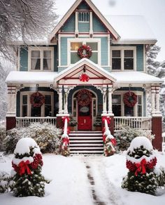 a house covered in snow with wreaths and decorations