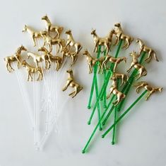 small gold horses on green sticks are sitting next to each other, and one is in front of them