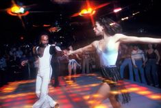 two people dancing on a dance floor at a party