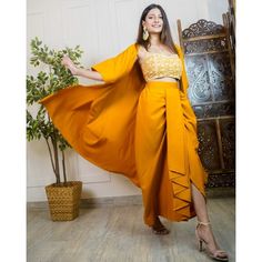 Made with absolute perfection, this 3 piece indo-western ethnic wear is perfect for wedding/party wear. It has an embroidered work crop top with a dhoti skirt and a long jacket. The fabric used is Viscose Sizes: S (bust-32inches, waist-29inches), M (bust-34inches, waist-31inches), L(bust-35.5inches, waist-33inches) Pattern: Embroidered Style: Indo-Western Dress For Women, Crop Top With Dhoti Skirt And Long Jacket Shrug Set, Indian Dress, Wedding Guest Outfit Occasion: Festive Wash Care: Hand Was