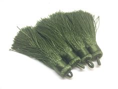 three green tassels on a white background