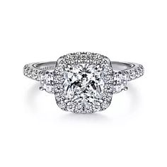 a cushion cut diamond engagement ring with halos