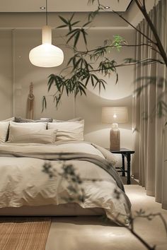 a bed with white sheets and pillows in a room next to two lamps on either side of the bed