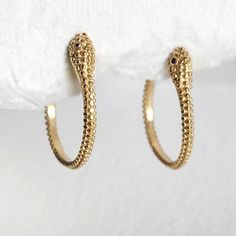 Gold plated high quality serpent hoop  earrings. Elegant addition. Handmade. Arrives in logo drawstring protective pouch Handmade Gold Snake Earrings, Handmade Snake Shape Earrings, Handmade Elegant Snake Earrings, Elegant Handmade Snake Earrings, Snake-shaped Yellow Gold Earrings For Gift, Handmade Gold Snake-shaped Earrings, Snake-shaped Earrings For Gifts, Gold Snake-shaped Earrings For Gift, Handmade Snake-shaped Earrings As Gift