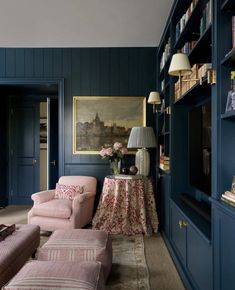 a living room filled with furniture and bookshelves