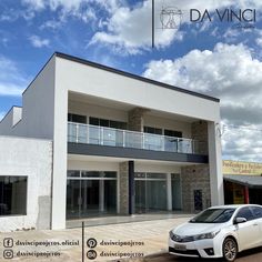 a white car parked in front of a building