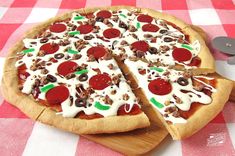 a pizza sitting on top of a wooden cutting board