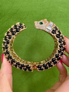 So classic and chic! Our modern panther bracelets are easy to mix and match with your vintage gold bracelets. They are made of gold plate with crystal details and glossy black resin stones, hand-set in Paris. Contemporary. Measures 2.5 x 2-inch internal diameter.Materials: Gold plate, crystal, resin. Luxury Metal Jewelry With Rhinestones, Designer Jeweled Gold Jewelry, Designer Gold Jeweled Jewelry, Designer Rhinestone Party Jewelry, Designer Rhinestone Jewelry For Party, Luxury Jeweled Gold Bracelets, Elegant Evening Jewelry With Handset Stones, Designer Rhinestone Jewelry For Formal Occasions, Luxury Formal Jewelry With Rhinestones