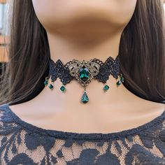 "This vintage gothic styled crystal choker necklace features lush Emerald Swarovski crystals with nice crisp facets and brass embellishments.  The detailed stampings have been in production since the 1940's and the vintage 16x11mm focal crystal is no longer in production, making this necklace a rare find. Both elegant and stylish, this piece would be perfect for any formal occasion. Swarovski Crystals are made in Austria and are the highest quality lead free glass-cut crystals on the market, with extra facets and gold foiling for outstanding brilliance and sparkle. The choker lace is 12.5\" long and includes a 3\"extension chain, totaling 15.5\" of length.  A pretty gold colored star hangs down from the chain in the back. Your treasure will ship promptly from the United States and in a fre Vintage Jeweled Choker As Gift, Vintage Jeweled Choker Gift, Vintage Metal Choker With Jewels, Vintage Jeweled Choker, Ornate Party Choker Jewelry, Vintage Jeweled Choker For Parties, Victorian Jeweled Jewelry For Party, Vintage Jeweled Choker Necklace, Victorian Rhinestone Jewelry Gift