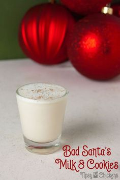 a glass filled with milk next to christmas ornaments