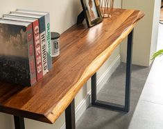 a wooden table with two books on it