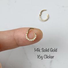 "14k Solid gold white opal Daith or White Opal Septum Ring Clicker Features: Sold as a Single - ONE Clicker Material - 14k Solid gold and High Quality White Lab Opal Gauge: 16g / 1.2mm Size: 6mm, 8mm, 10mm High Polished Coming with a Gift Box WE CAREFULLY INSPECT ALL OF MY PIECES BEFORE THEY LEAVE THE STUDIO. IF EVER AN ITEM ARRIVES DAMAGED, IT MUST BE REPORTED TO ME IMMEDIATELY- WITHIN 24HRS AFTER DELIVERY. We take all responsibility of BROKEN ITEMS in 5 DAYS AFTER DELIVERY. * Return or Exchang Opal Septum, White Opal Earrings, Daith Earrings, Ear Style, Piercings Unique, White Lab, Opal Earrings Stud, Opal Studs, Cz Stud Earrings